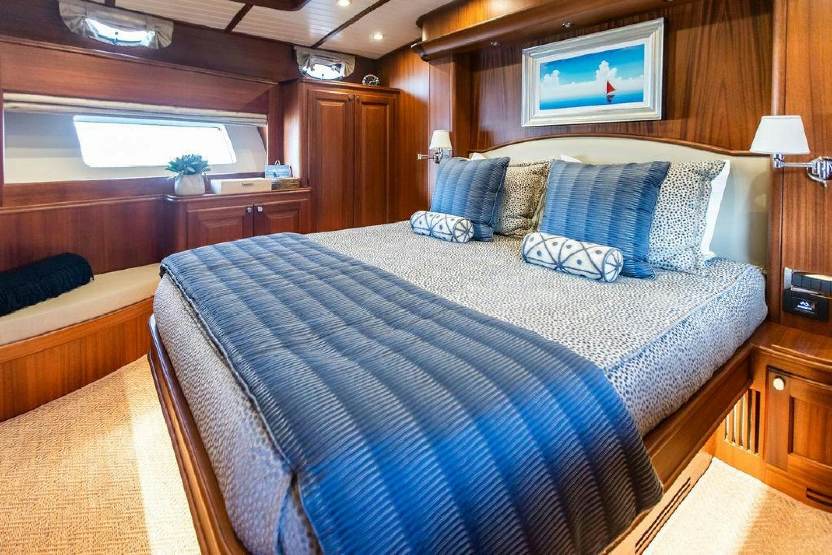 a bed with blue sheets aboard JESSICA Yacht for Sale