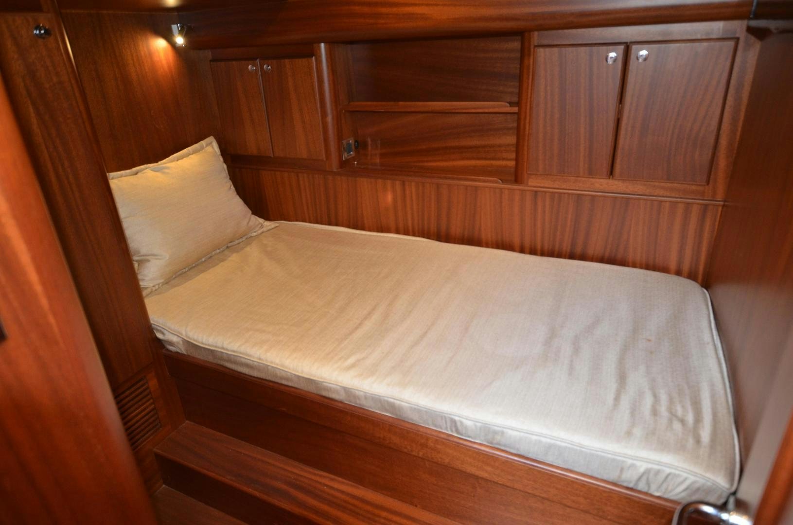 a bed with a white sheet aboard JESSICA Yacht for Sale