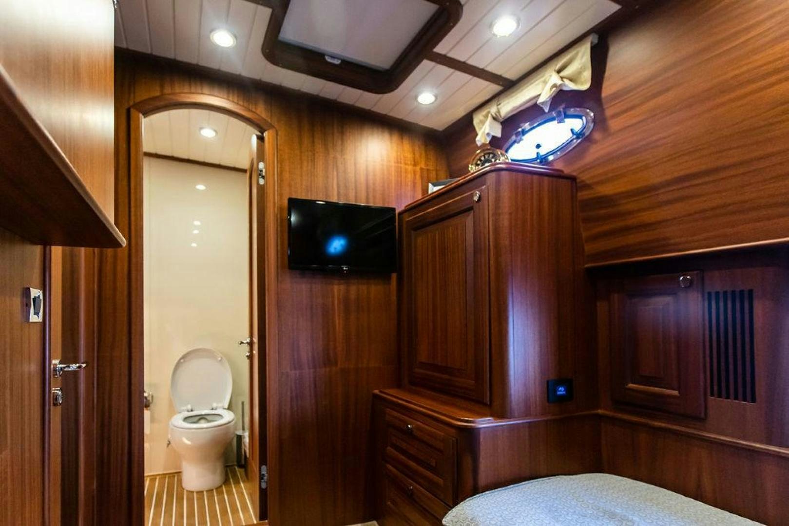 a bathroom with a toilet and a television aboard JESSICA Yacht for Sale