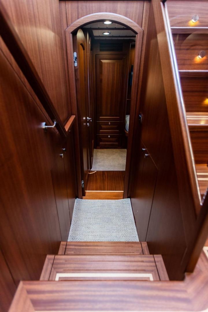 a wooden hallway with a wood door aboard JESSICA Yacht for Sale