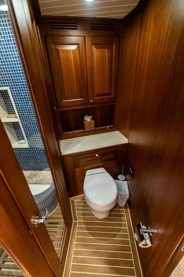a bathroom with wooden cabinets aboard JESSICA Yacht for Sale