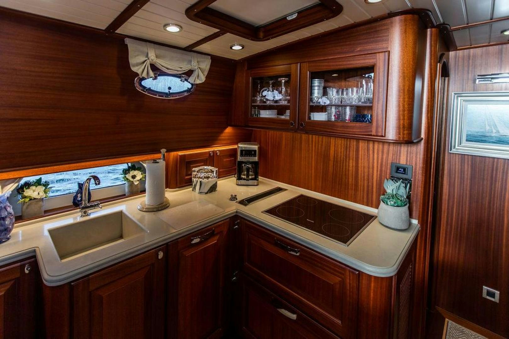a kitchen with wooden cabinets aboard JESSICA Yacht for Sale