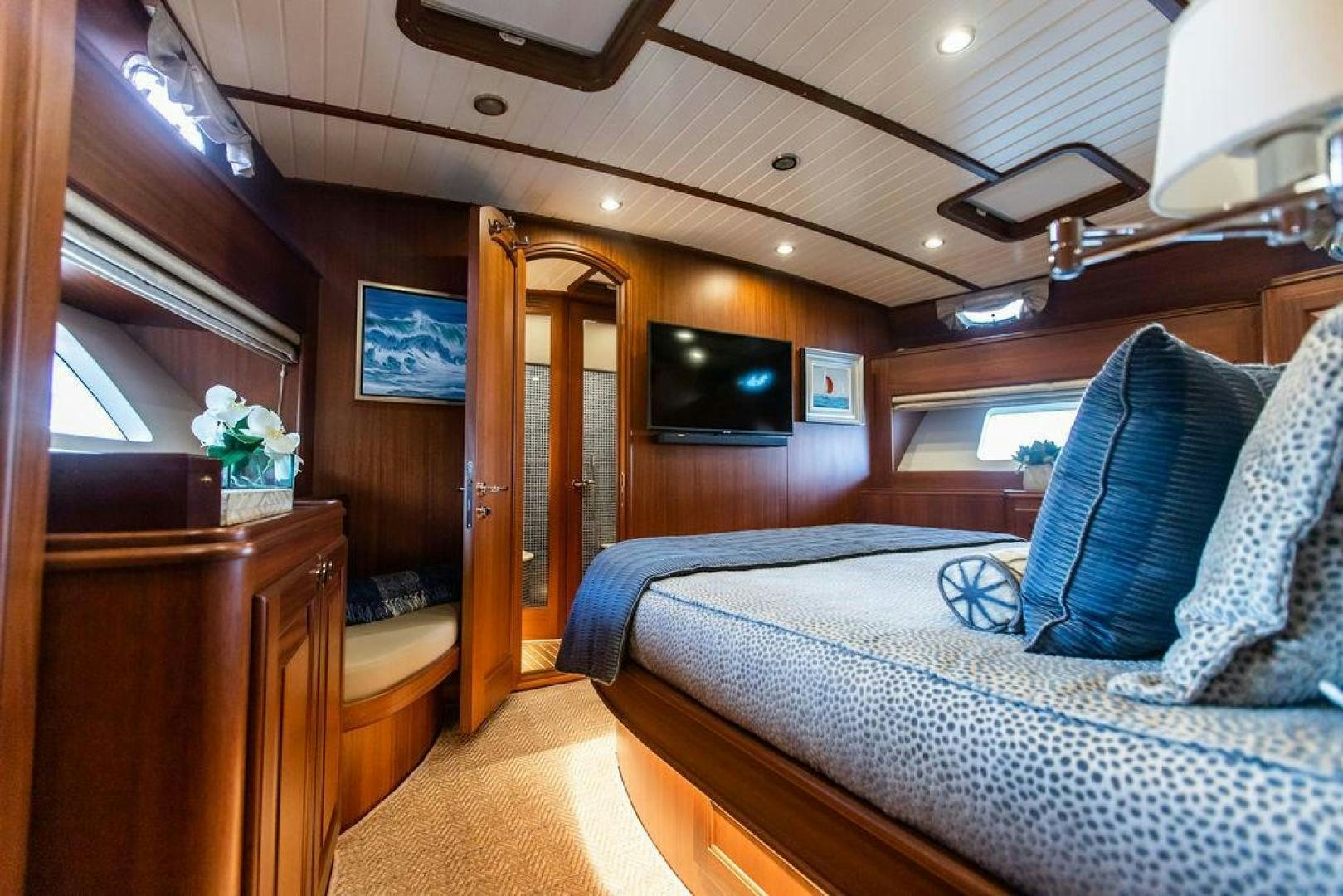 a bedroom with a bed and a television aboard JESSICA Yacht for Sale