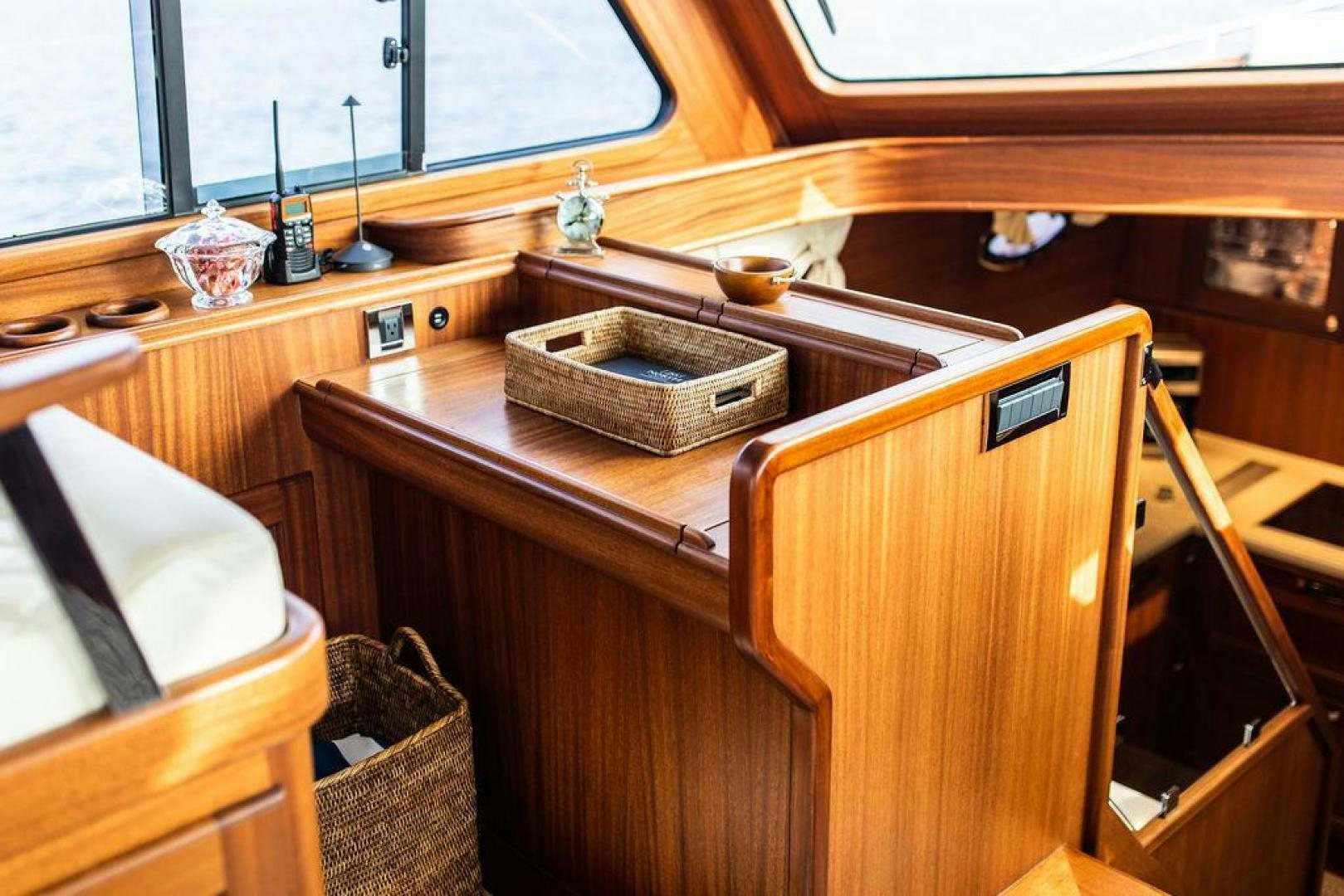 a wooden table with a basket on it aboard JESSICA Yacht for Sale
