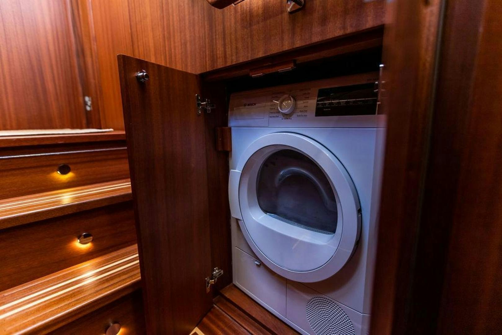 a small washer in a wooden room aboard JESSICA Yacht for Sale