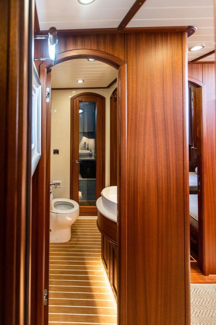 a bathroom with a wood door aboard JESSICA Yacht for Sale
