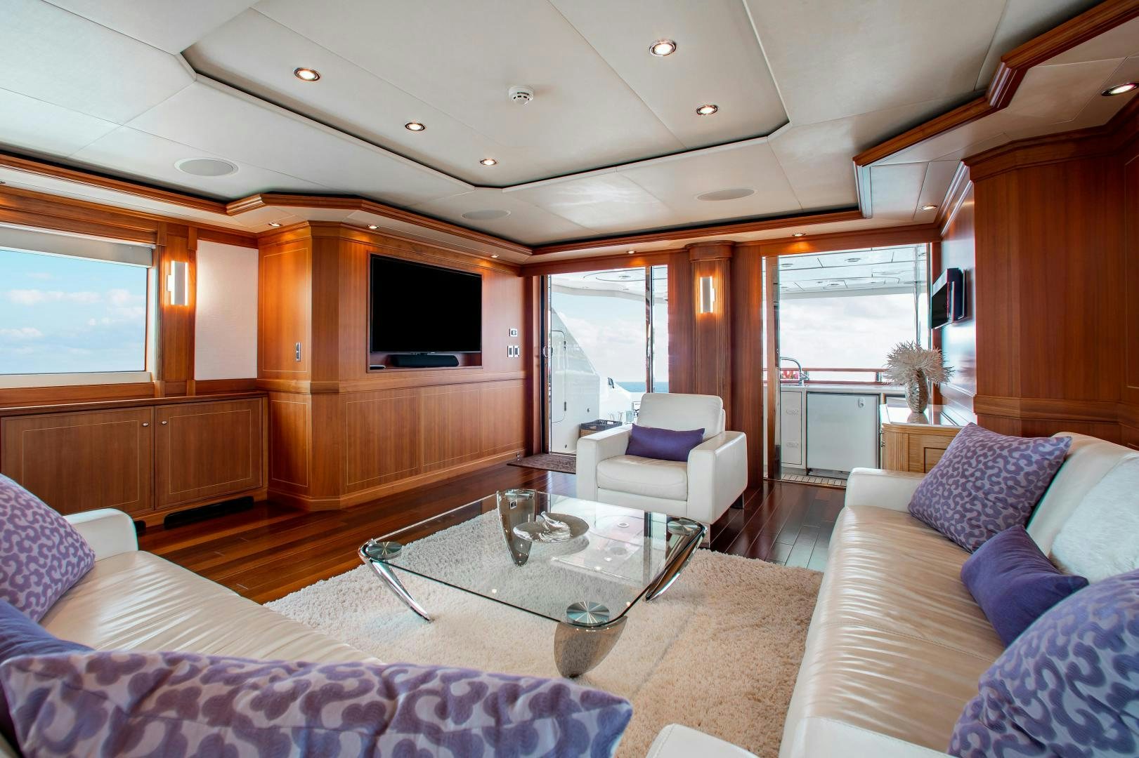 a living room with a table and couches aboard BLACKSHEEP Yacht for Sale