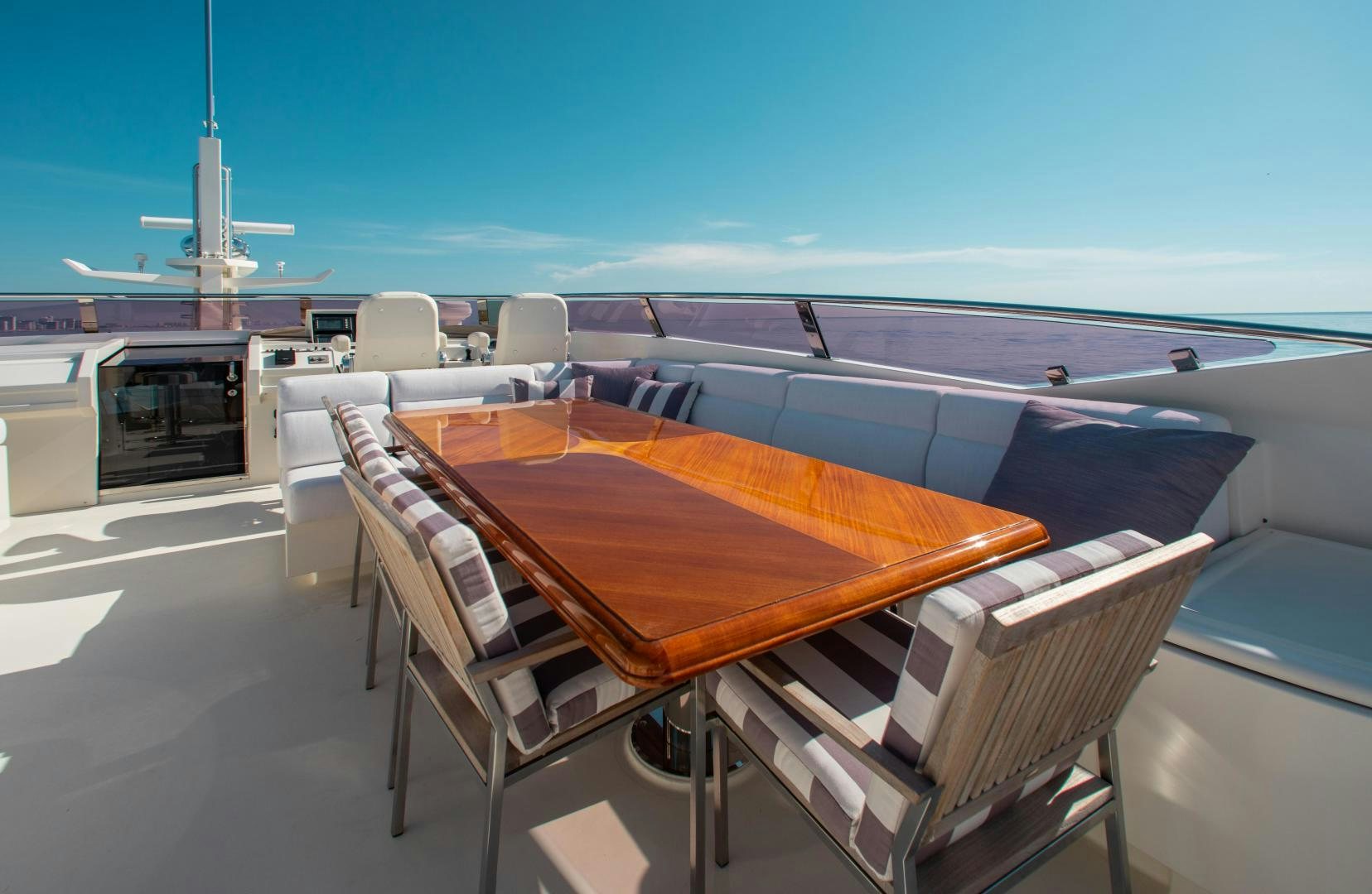 a table and chairs on a deck aboard BLACKSHEEP Yacht for Sale