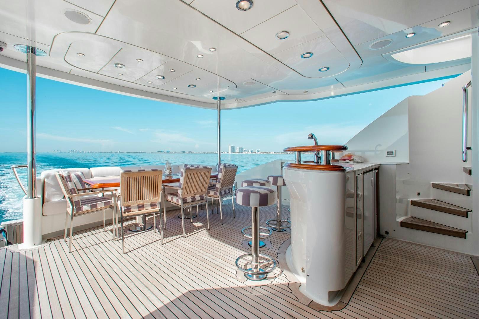 a room with a balcony and a view of the ocean aboard BLACKSHEEP Yacht for Sale
