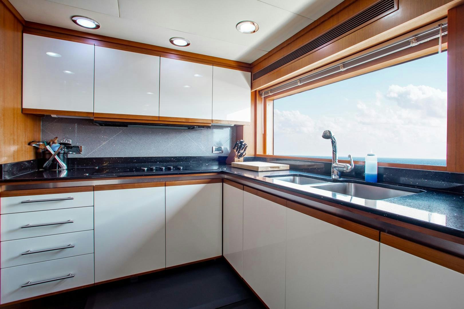 a kitchen with a large window aboard BLACKSHEEP Yacht for Sale