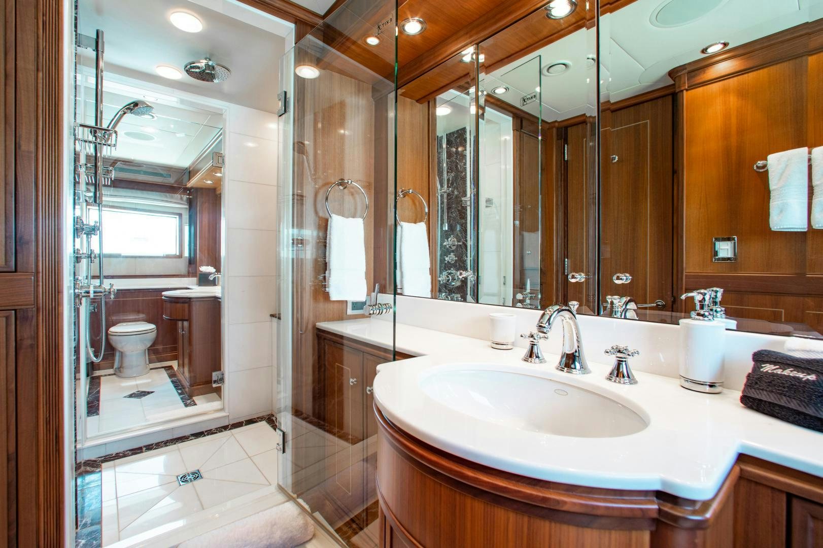 a bathroom with a large mirror aboard BLACKSHEEP Yacht for Sale