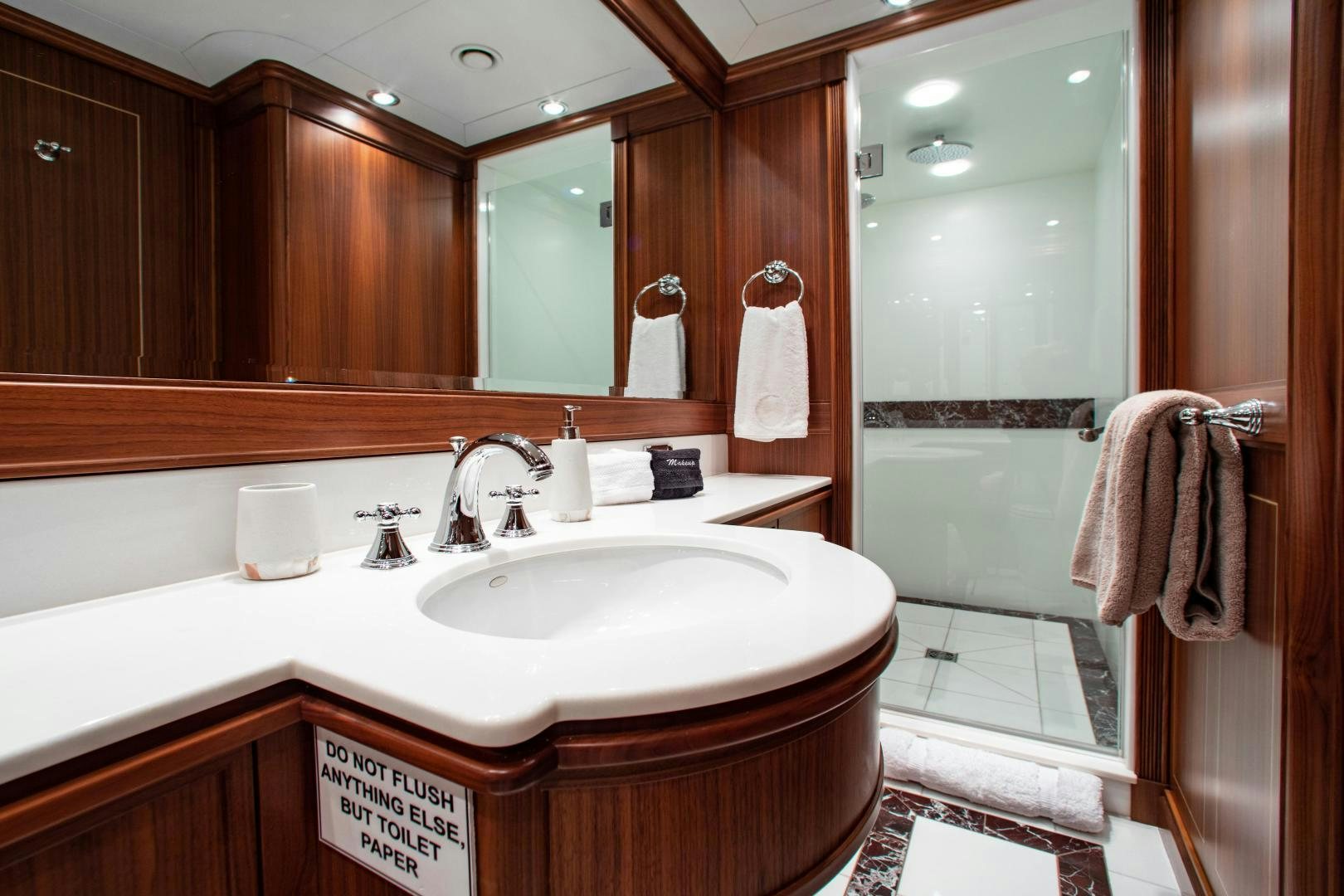 a bathroom with a sink and a mirror aboard BLACKSHEEP Yacht for Sale