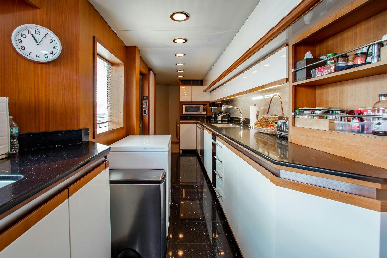 a kitchen with a large clock aboard BLACKSHEEP Yacht for Sale