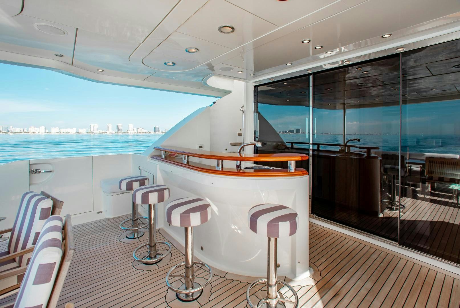 a table and chairs on a deck aboard BLACKSHEEP Yacht for Sale