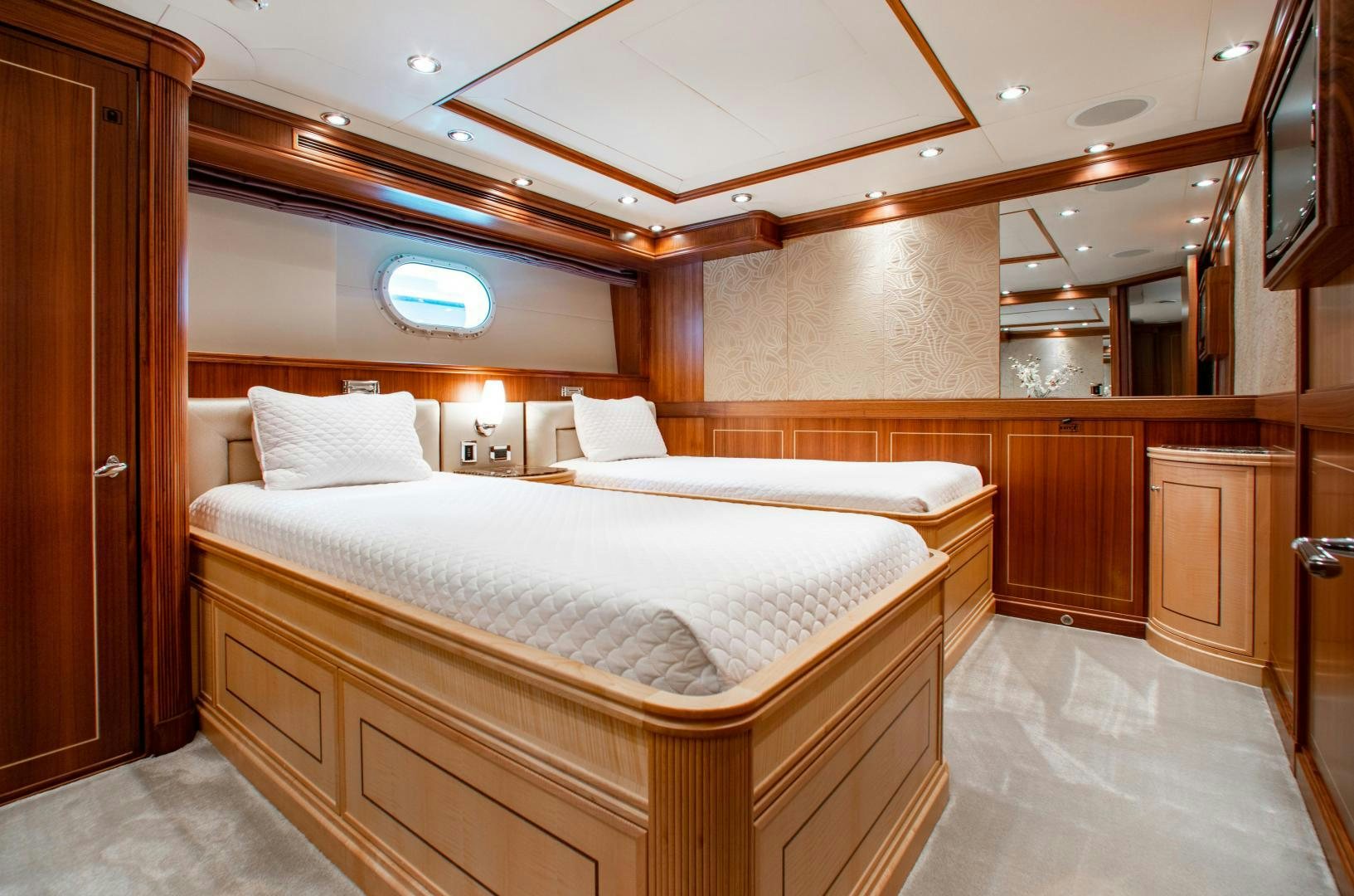 a room with a bed and a mirror aboard BLACKSHEEP Yacht for Sale