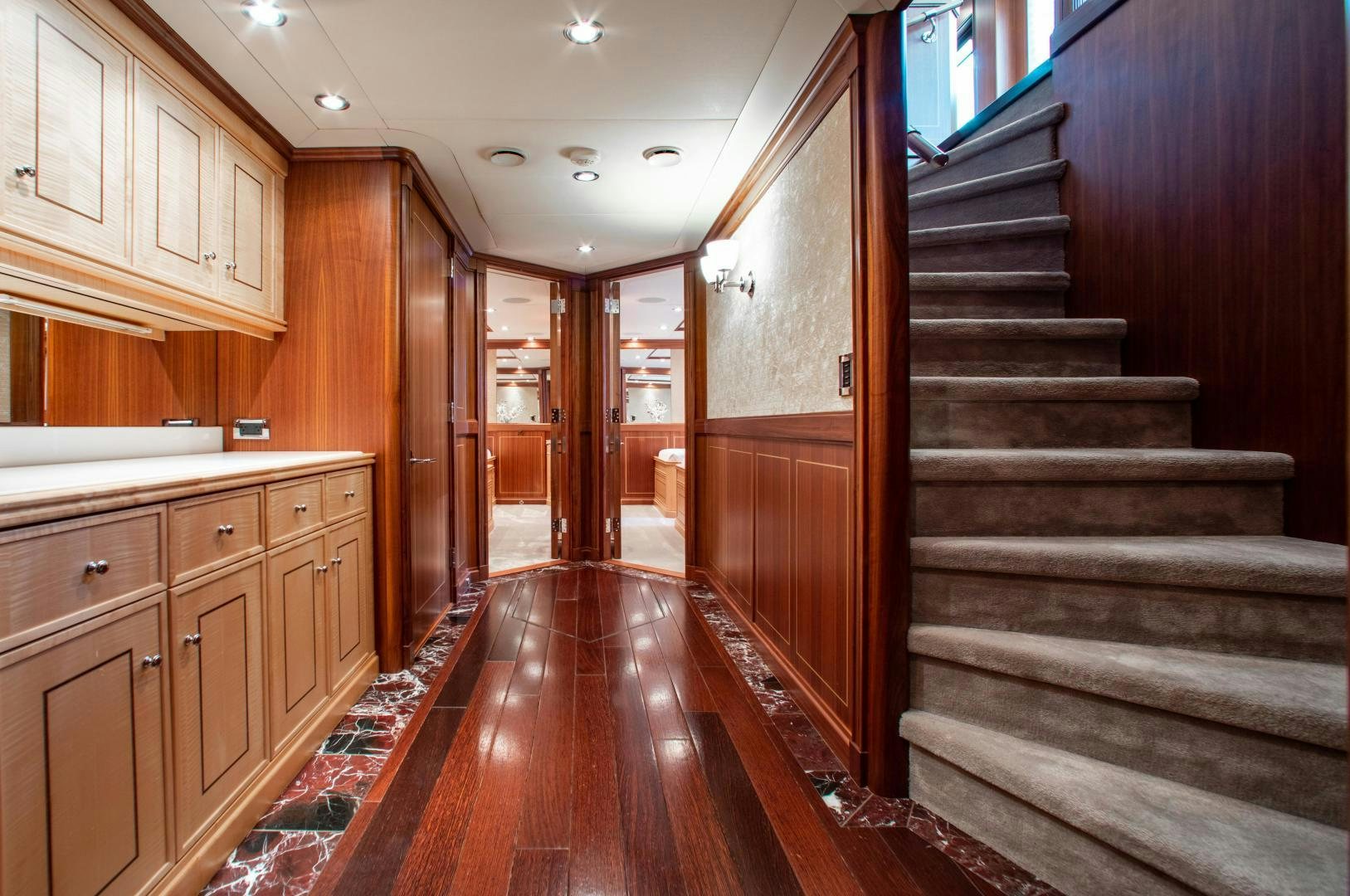 a wood staircase in a room aboard BLACKSHEEP Yacht for Sale