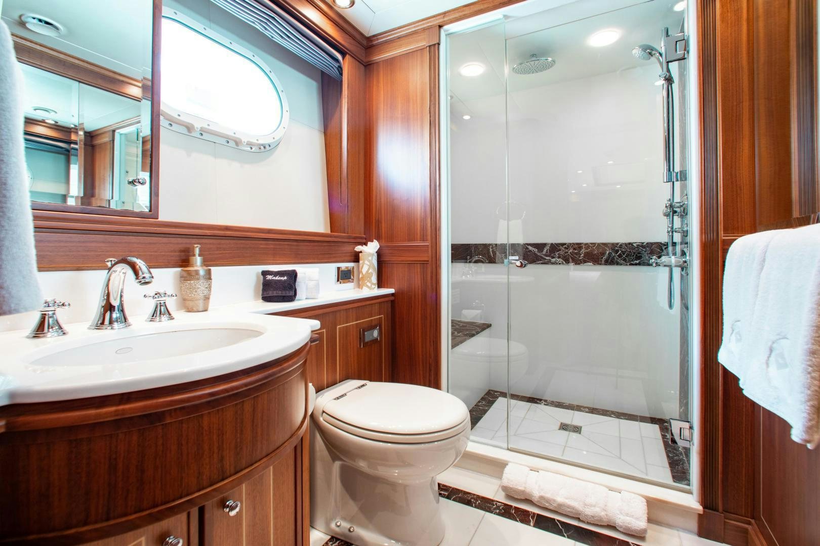 a bathroom with a glass shower door aboard BLACKSHEEP Yacht for Sale