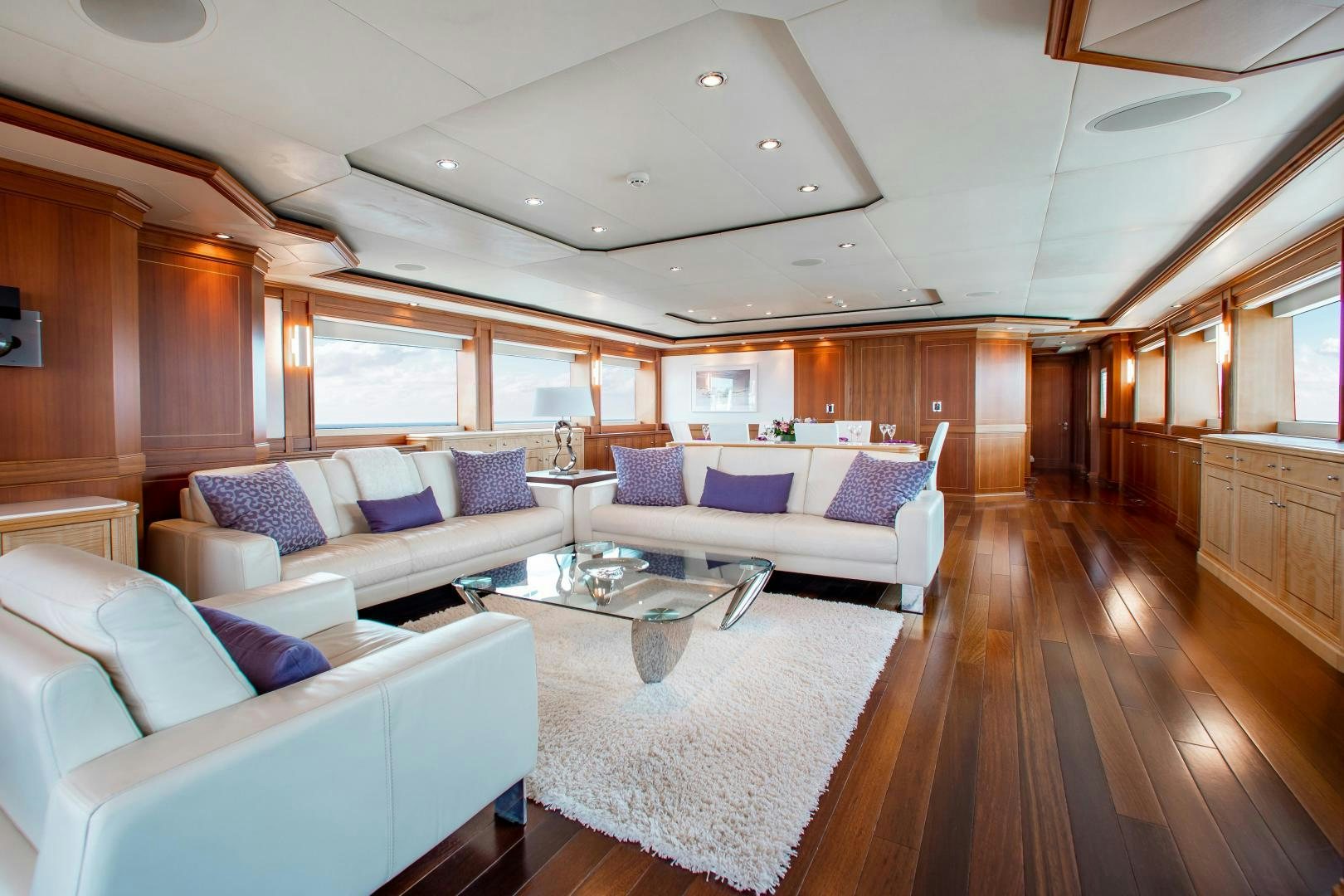 a large living room with a large white table and couches aboard BLACKSHEEP Yacht for Sale
