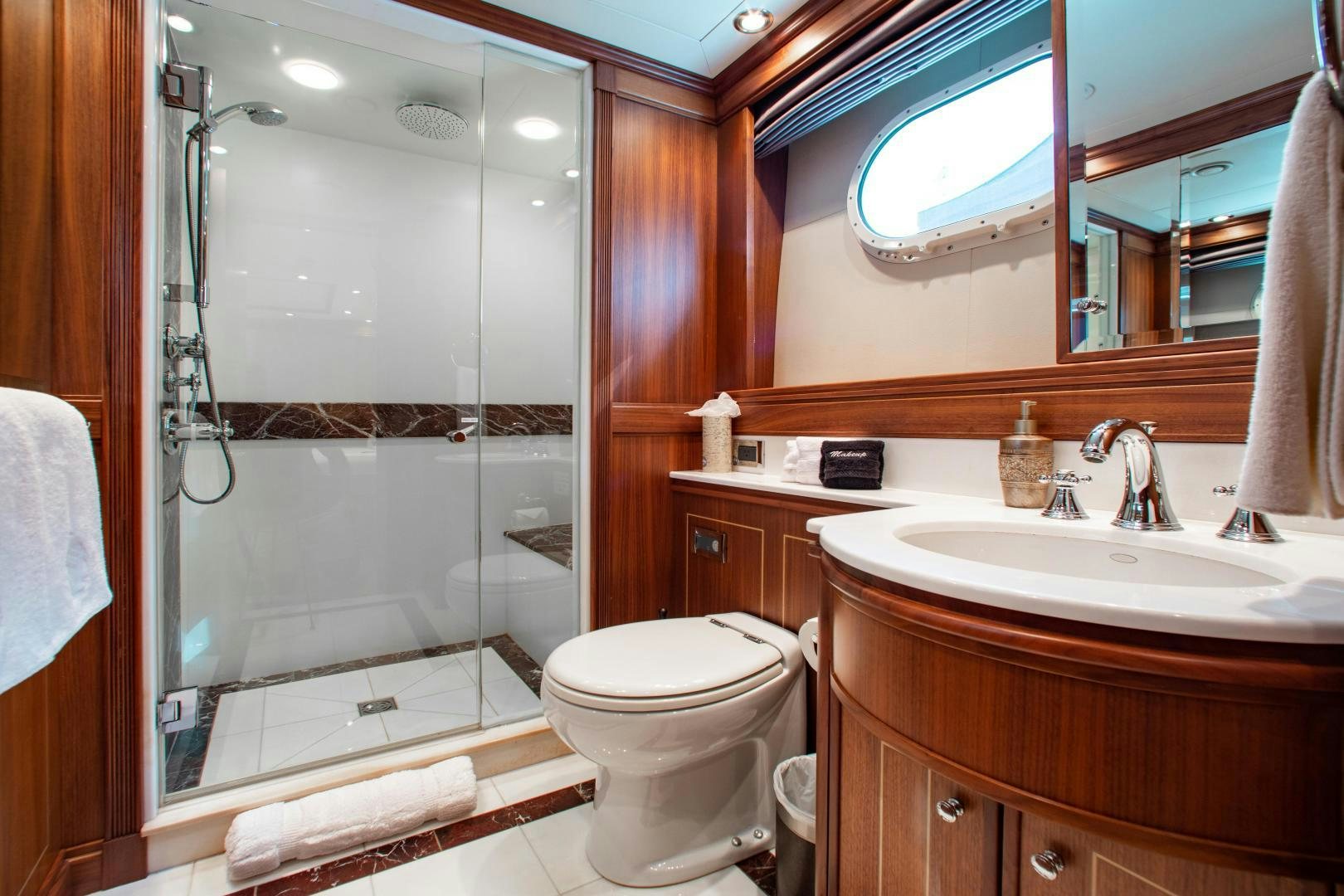 a bathroom with a glass shower door aboard BLACKSHEEP Yacht for Sale