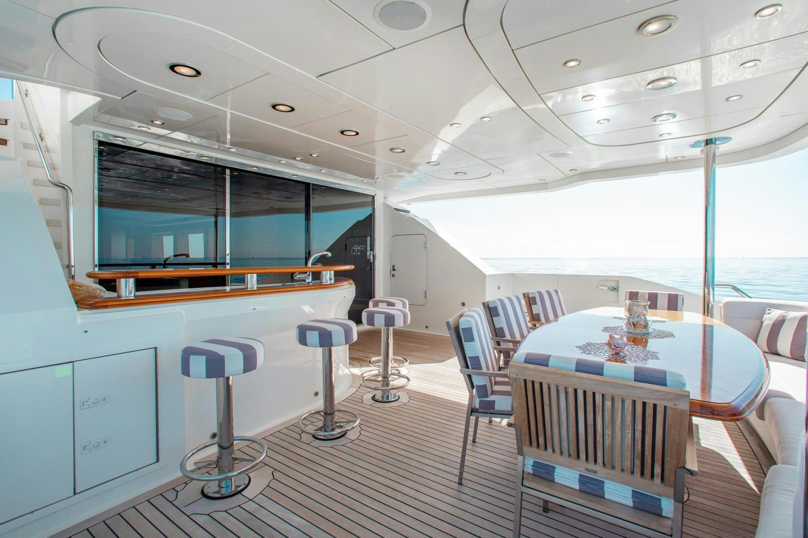 a room with tables and chairs aboard BLACKSHEEP Yacht for Sale