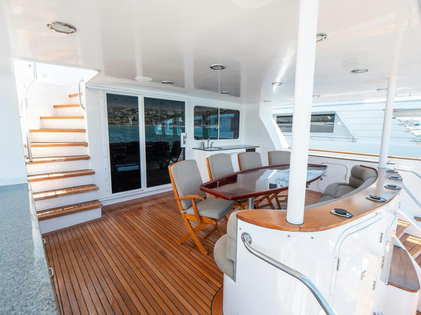 a room with a table chairs and a staircase aboard LONE WOLF Yacht for Sale