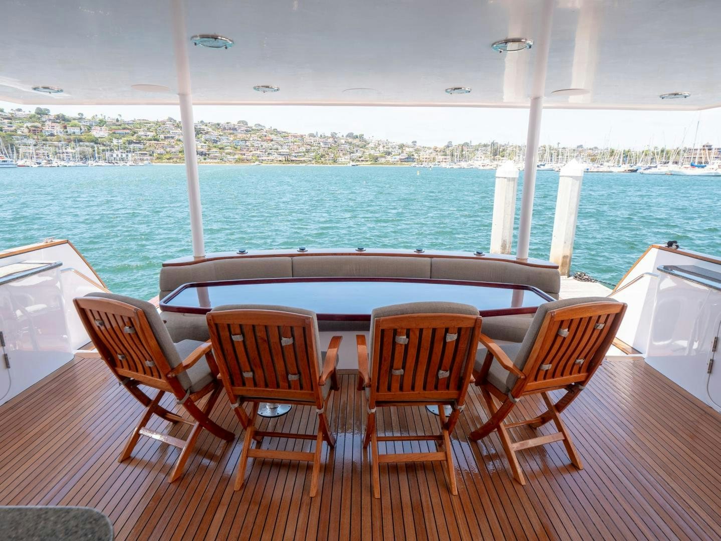 a table and chairs on a deck overlooking a body of water aboard LONE WOLF Yacht for Sale