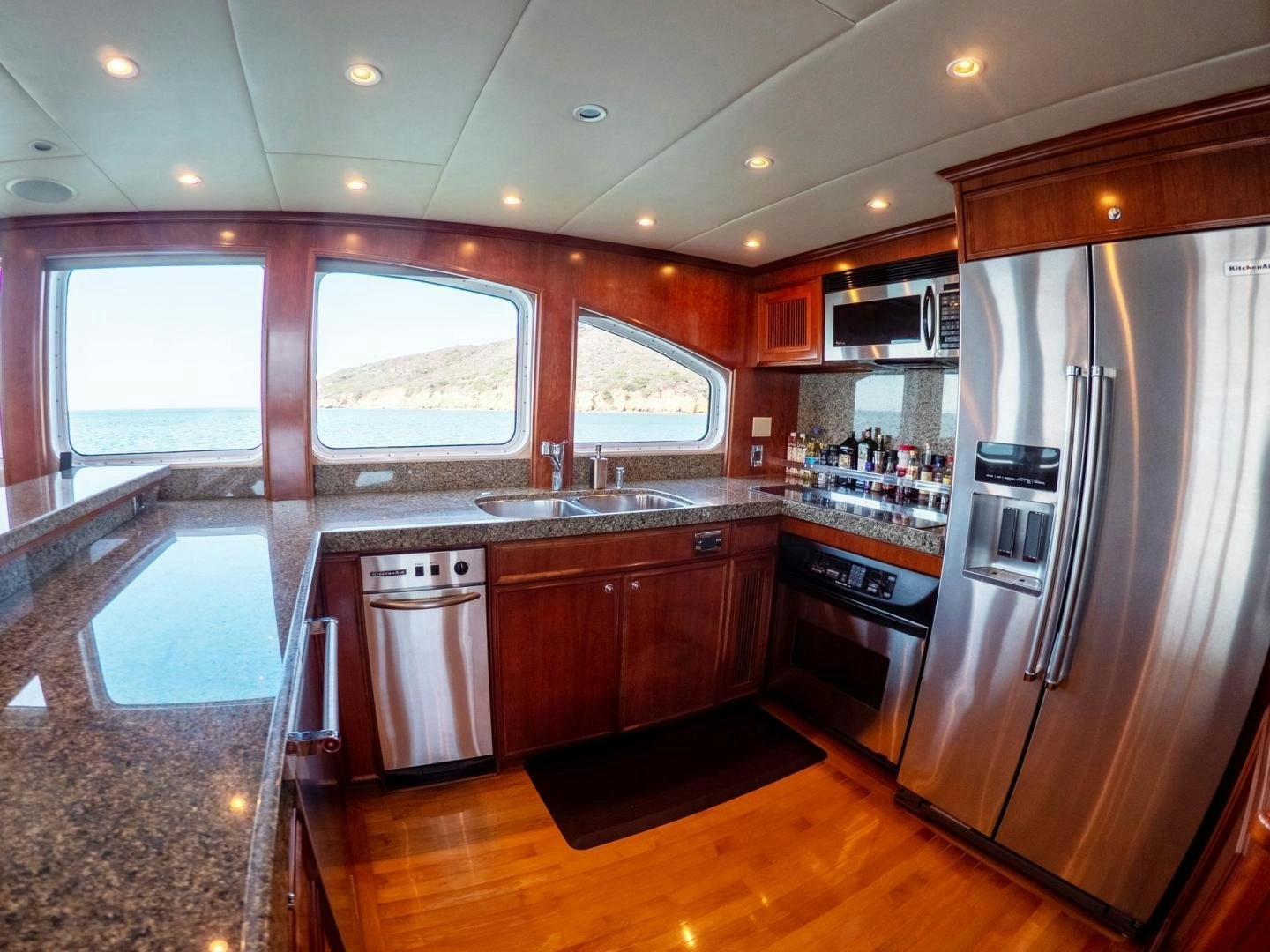 a kitchen with a stainless steel refrigerator aboard LONE WOLF Yacht for Sale