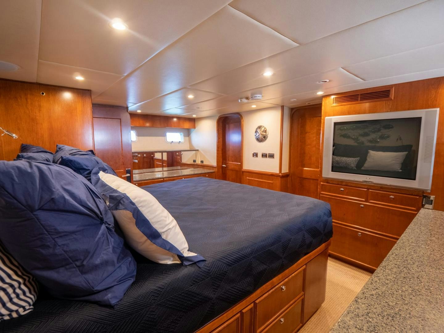 a bedroom with a bed and a television aboard LONE WOLF Yacht for Sale