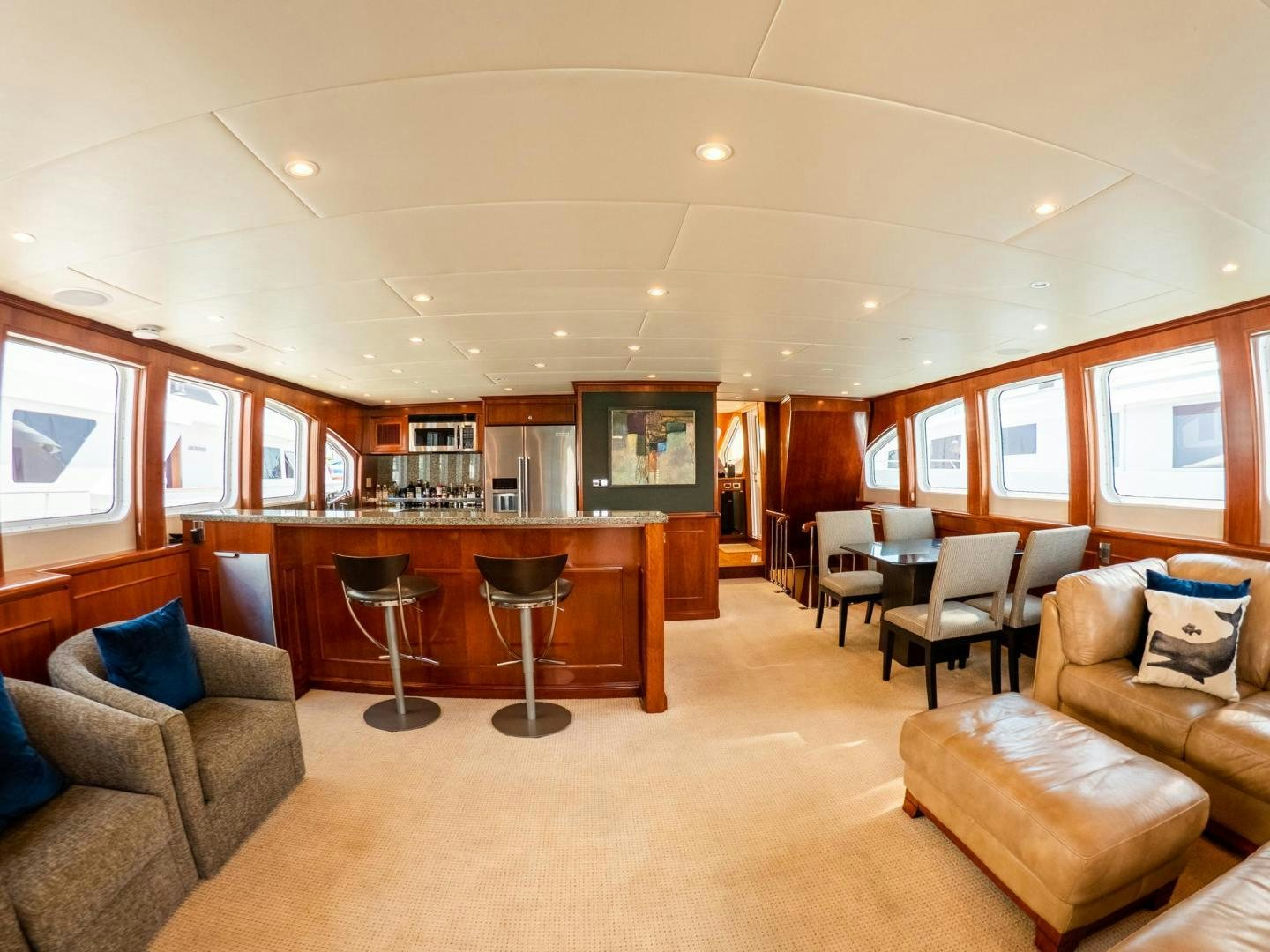 a living room with a wood table and chairs aboard LONE WOLF Yacht for Sale