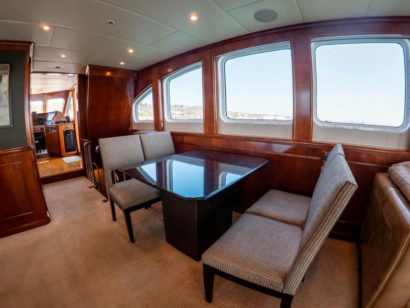 a living room with a table and chairs aboard LONE WOLF Yacht for Sale