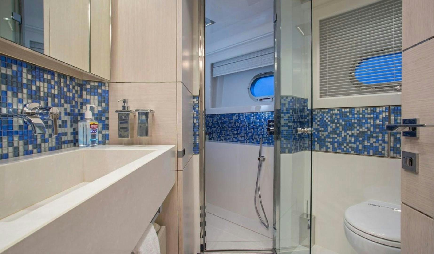 a bathroom with a bathtub and toilet aboard ALANDREA Yacht for Sale