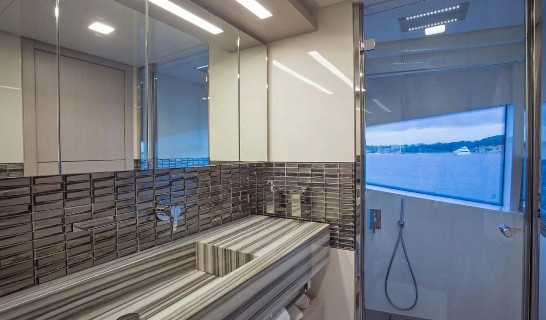 a bathroom with a glass shower aboard ALANDREA Yacht for Sale