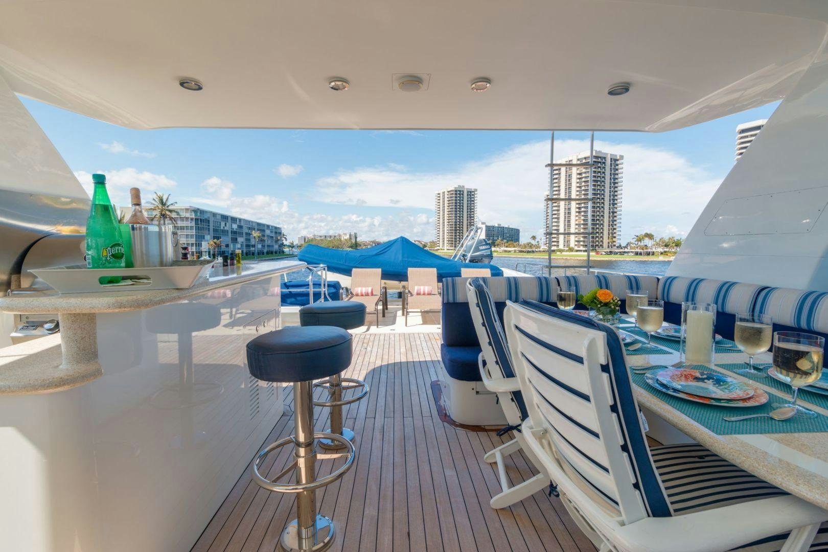 a room with a table chairs and a view of the water aboard WINDWARD Yacht for Sale