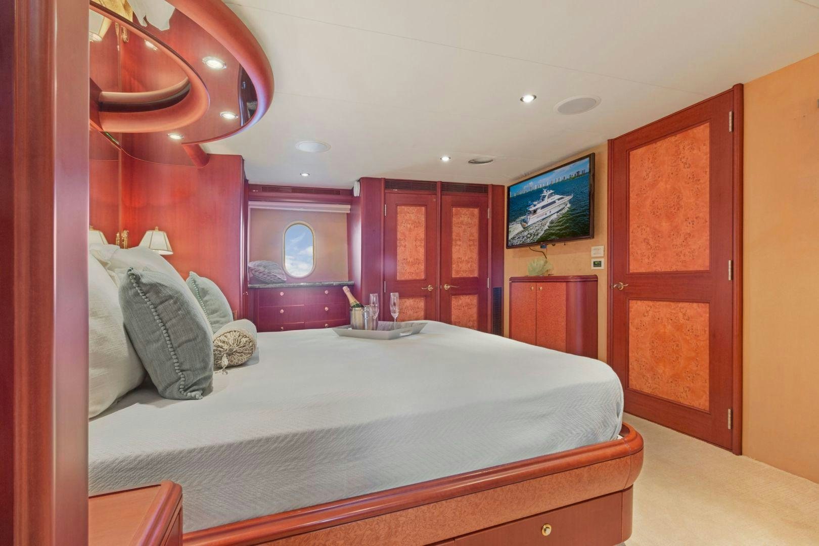 a bedroom with a bed and a mirror aboard WINDWARD Yacht for Sale