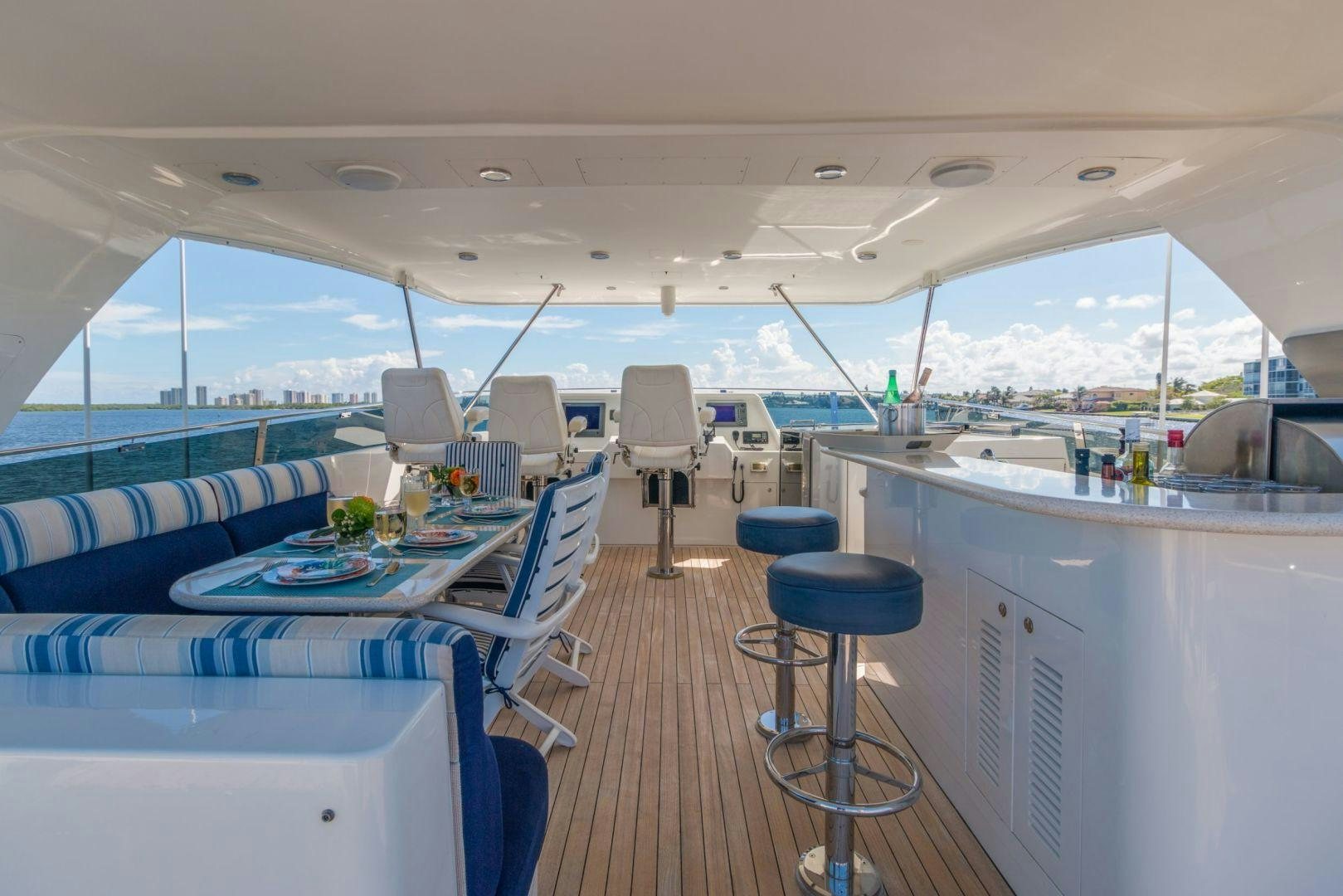 a boat with a table and chairs aboard WINDWARD Yacht for Sale