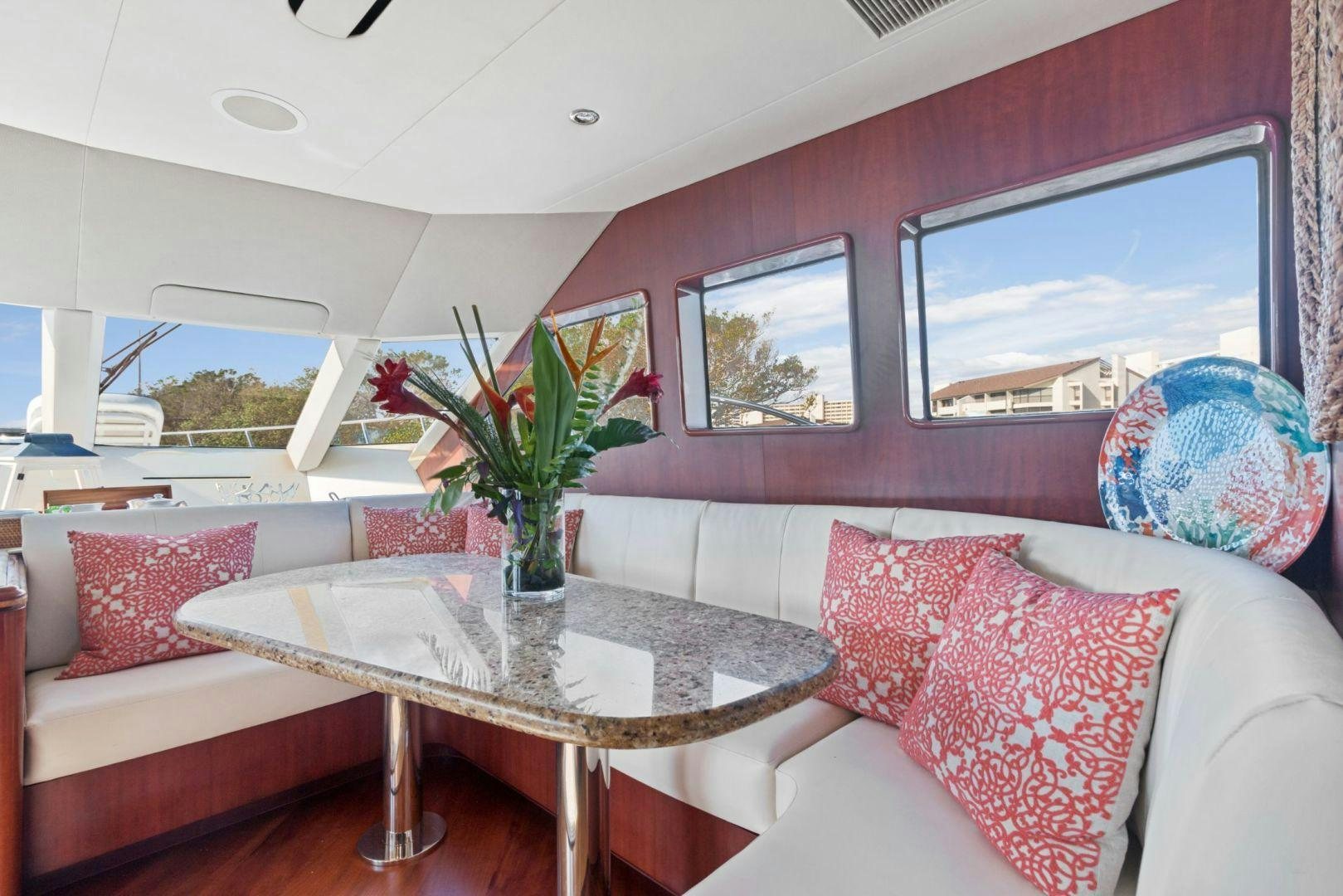a living room with a table and couches aboard WINDWARD Yacht for Sale