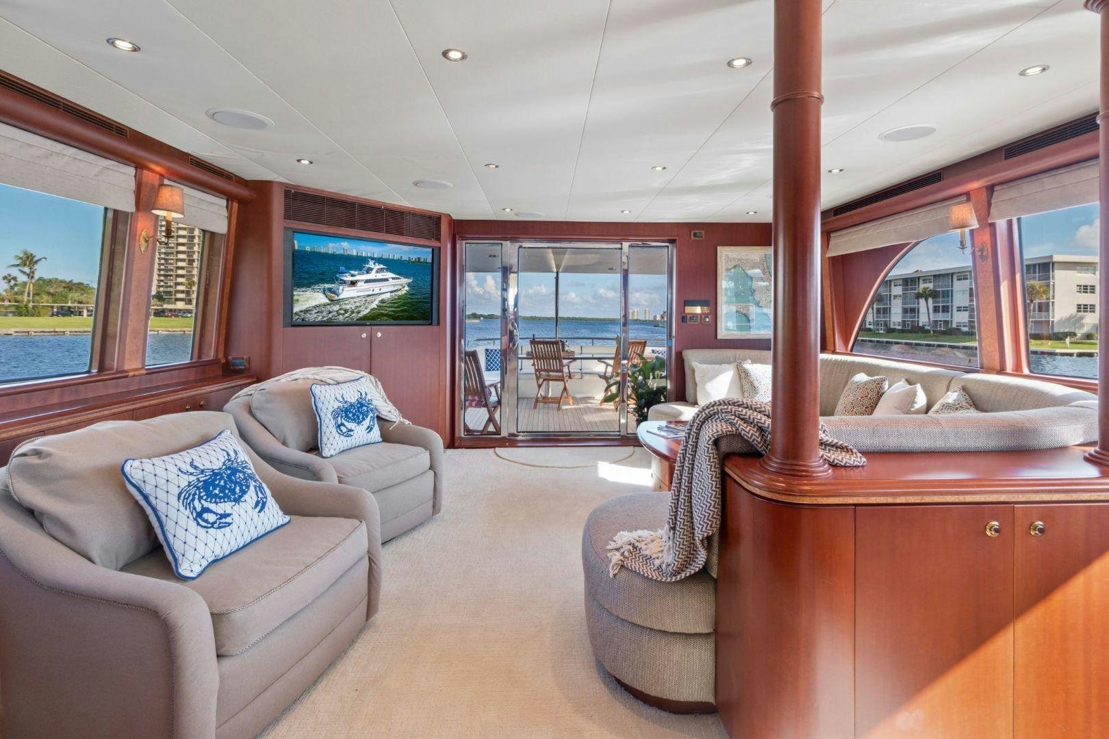 a living room with a couch and a television aboard WINDWARD Yacht for Sale