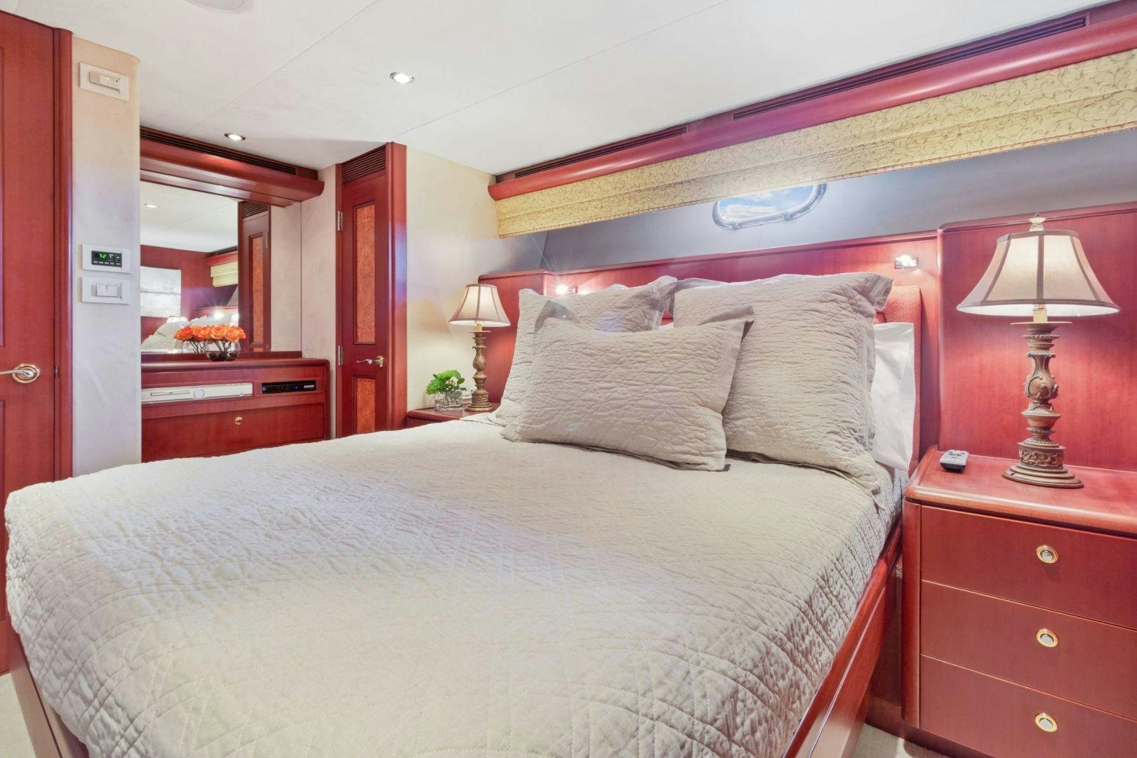 a bed with a white comforter aboard WINDWARD Yacht for Sale