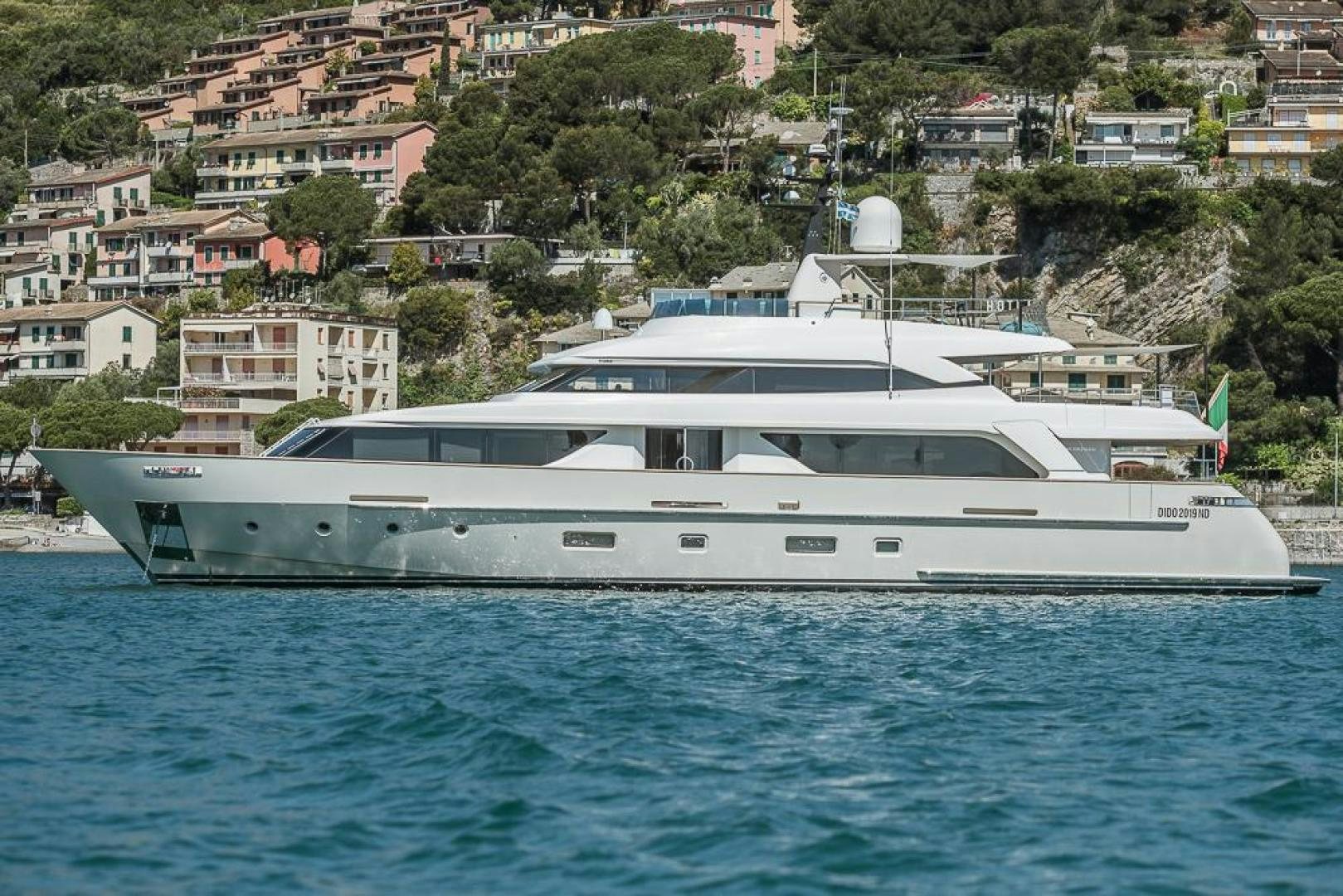 a large white yacht in the water aboard AKAR XIII Yacht for Sale