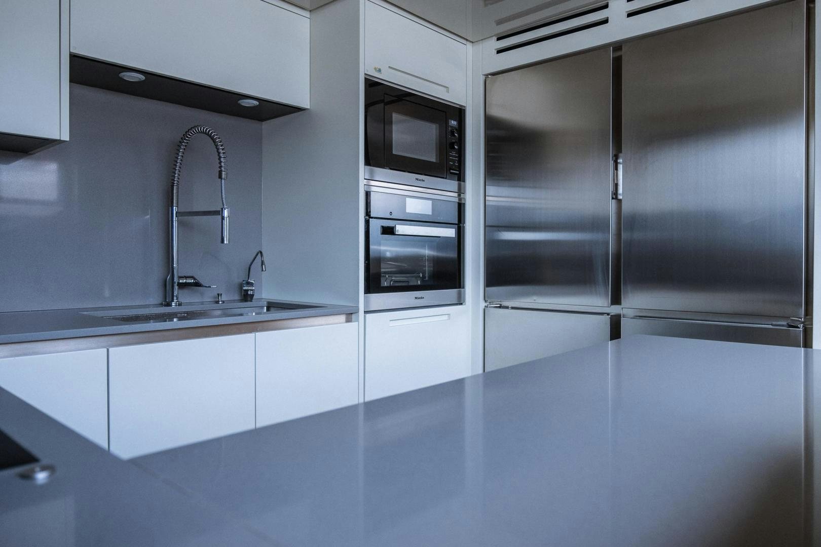 a kitchen with a stainless steel refrigerator aboard AKAR XIII Yacht for Sale