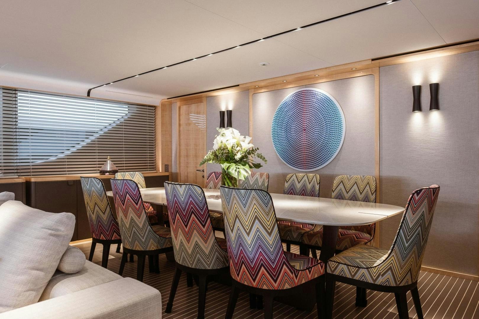 a room with chairs and a table aboard AKAR XIII Yacht for Sale