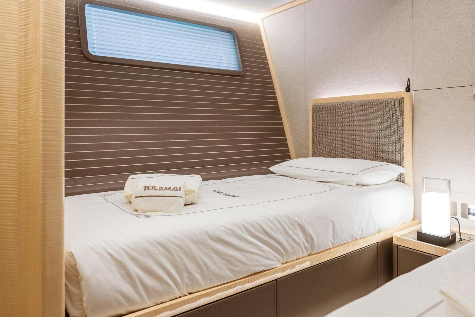 a bed with a white sheet aboard AKAR XIII Yacht for Sale