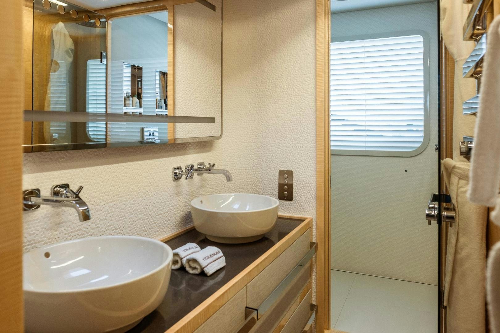 a bathroom with a sink and mirror aboard AKAR XIII Yacht for Sale