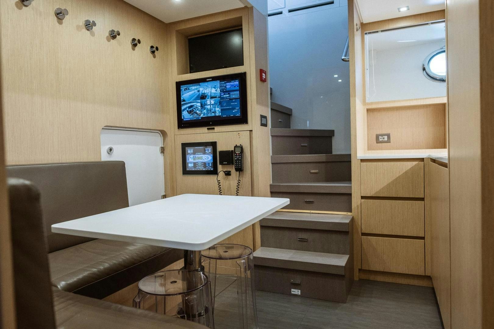 a room with a desk and a tv on the wall aboard AKAR XIII Yacht for Sale