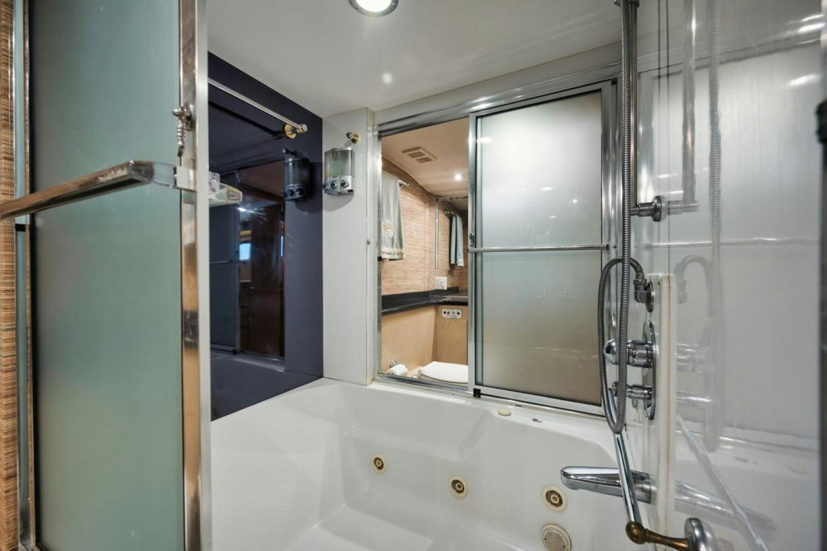 a bathroom with a tub and shower aboard HATT'S OFF Yacht for Sale