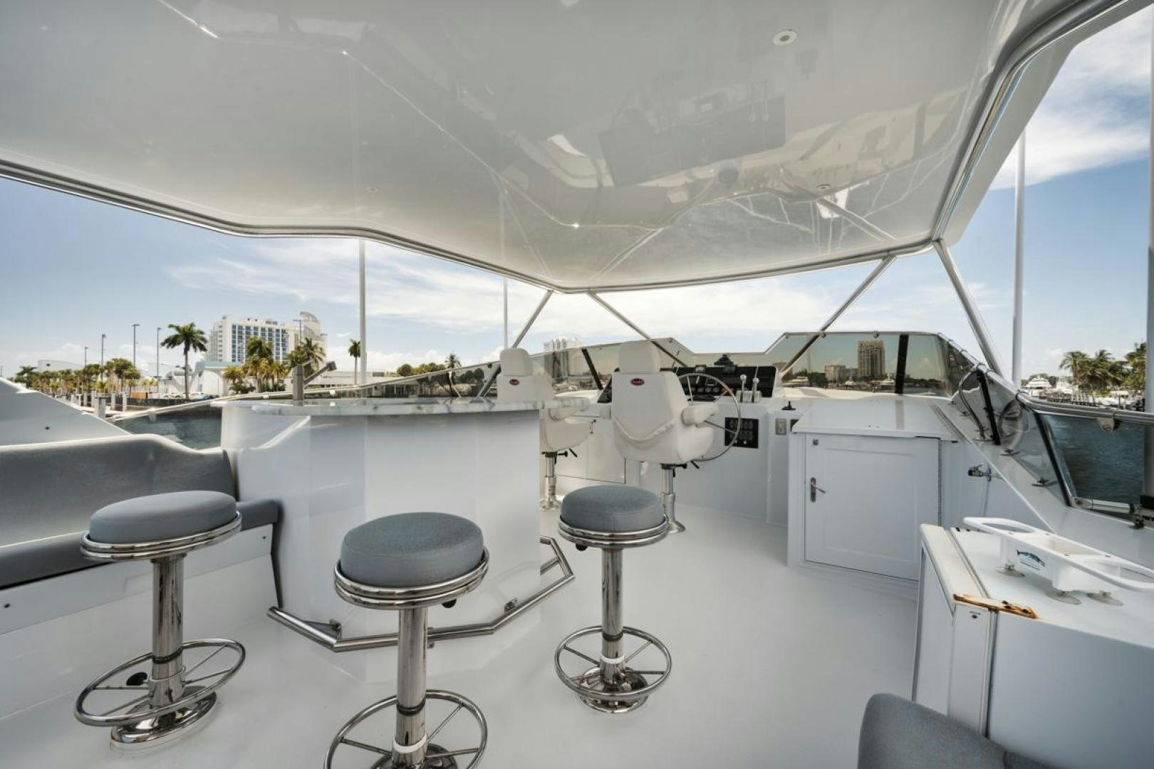a room with a table chairs and a large window aboard HATT'S OFF Yacht for Sale
