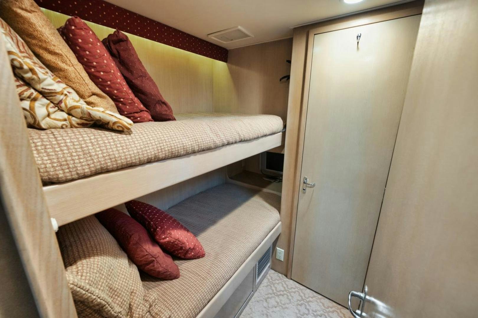 a bed with a red pillow aboard HATT'S OFF Yacht for Sale
