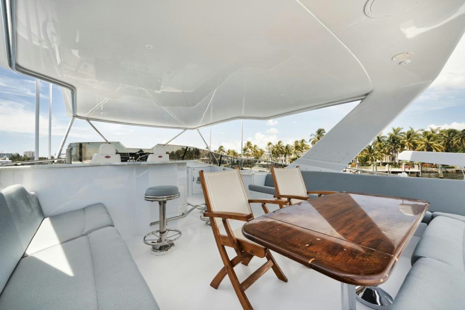 a boat with a table and chairs on it aboard HATT'S OFF Yacht for Sale