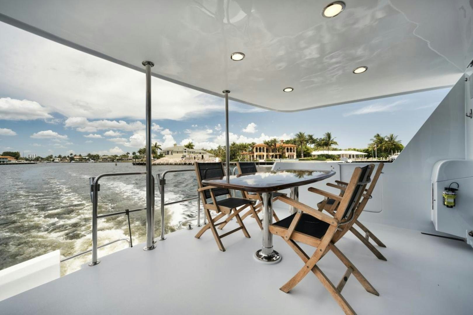 a table and chairs on a balcony aboard HATT'S OFF Yacht for Sale
