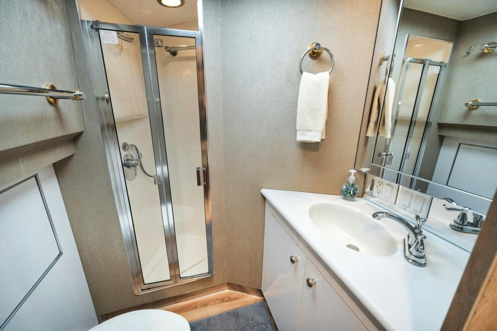 a bathroom with a glass shower door aboard HATT'S OFF Yacht for Sale